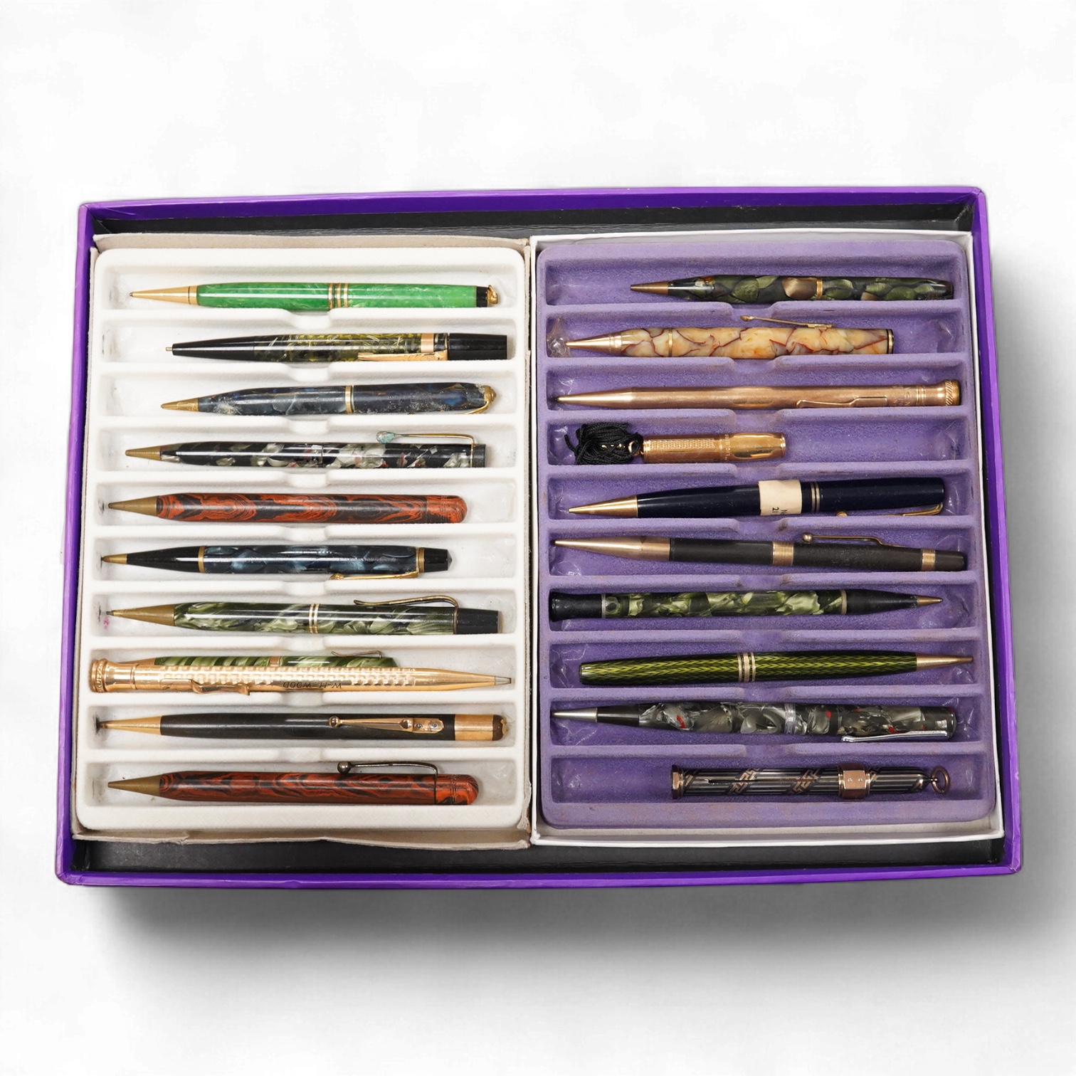 A collection of vintage pencils including an early enamel example